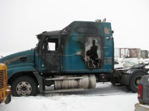 A semi truck with its door open in the snow.