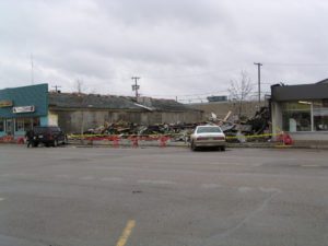 A car parked in the middle of an empty parking lot.