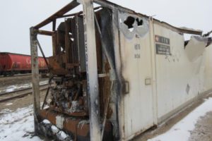 A white and rusty container sitting in the snow.